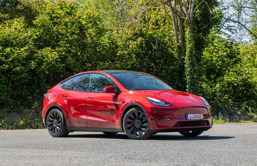 Red Tesla Model Y parked front and right side
